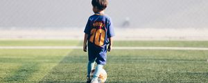 Preview wallpaper child, football player, football, football field, ball, lawn