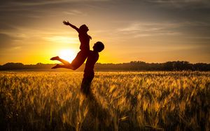 Preview wallpaper couple, love, sunset, field, grass, silhouettes