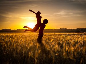 Preview wallpaper couple, love, sunset, field, grass, silhouettes