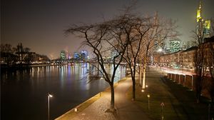 Preview wallpaper evening, frankfurt, channel, strait, water, boat, pier, lights, bridge, park, trees, railroad tracks, houses, buildings, skyscrapers, wall, distance, road