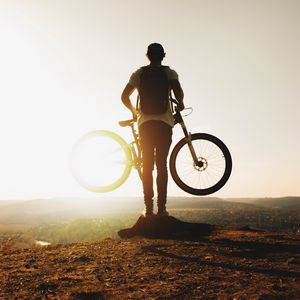 Preview wallpaper guy, bike, sun, mountains, active