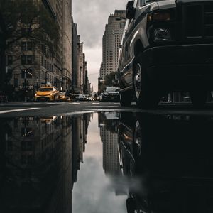 Preview wallpaper street, puddle, reflection, cars, buildings, asphalt